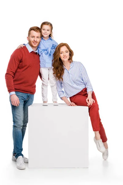 Beautiful happy redhead family with one child smiling at camera isolated on white — Stock Photo