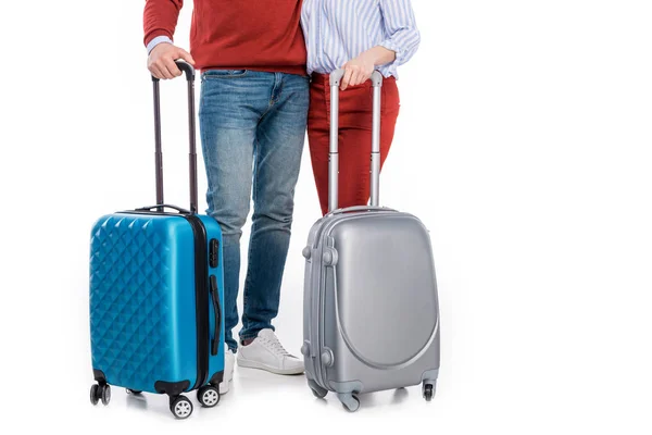 Cropped shot of couple with suitcases standing together isolated on white — Stock Photo