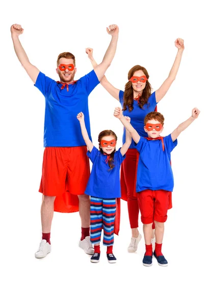 Happy super family in costumes raising hands and smiling at camera isolated on white — Stock Photo