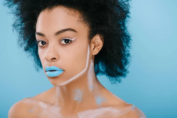 Attractive young woman with creative makeup and afro hairstyle isolated on blue — Stock Photo