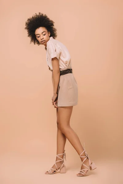 Beautiful african american woman in stylish clothes on beige — Stock Photo