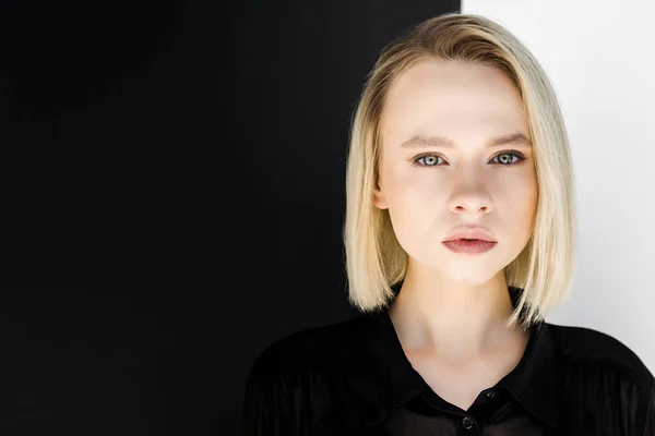 Portrait of attractive stylish blonde woman in black clothes looking at camera — Stock Photo