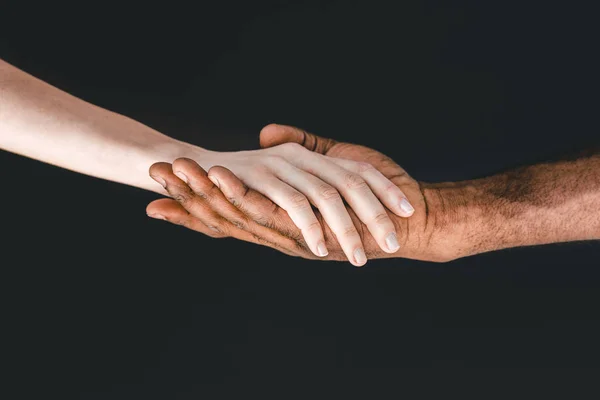 Cropped image of african american boyfriend and girlfriend holding hands isolated on black — Stock Photo