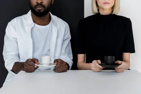 Cropped image of african american boyfriend and blonde girlfriend holding cups of coffee — Stock Photo