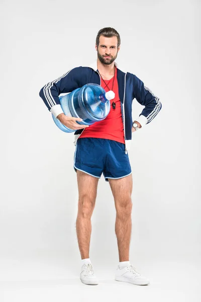 Sportlicher Trainer mit großer Wasserflasche, isoliert auf weiß — Stockfoto