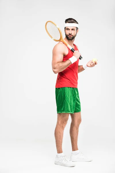 Sportive tennis player posing with retro wooden racket and ball, isolated on white — Stock Photo