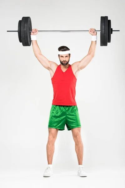 Strong sportsman holding barbell, isolated on white — Stock Photo