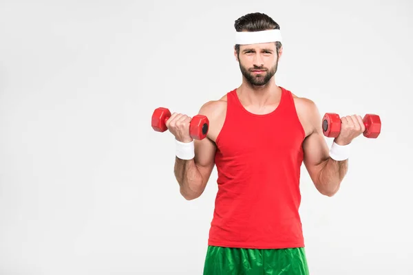 Deportista retro haciendo ejercicio con pesas, aislado sobre blanco - foto de stock