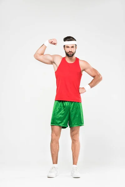 Handsome sportsman in retro sportswear showing muscles, isolated on white — Stock Photo