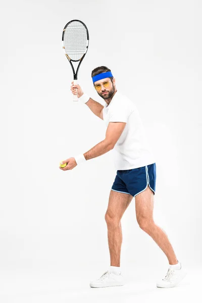 Desportista em óculos retro jogando tênis com raquete e bola, isolado em branco — Fotografia de Stock