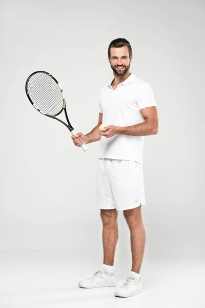 Male tennis player with ball and racket, isolated on grey — Stock Photo