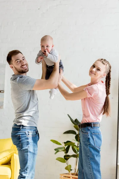 Happy parents playing with little son at home — Stock Photo