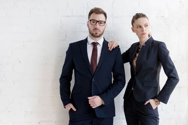 Confident business coworkers posing together near white wall — Stock Photo