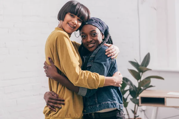 Young multicultural female friends hugging each other — Stock Photo