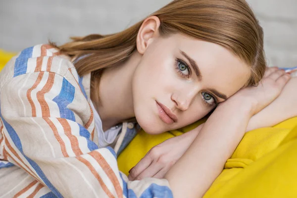 Portrait of young attractive woman laying on couch — Stock Photo