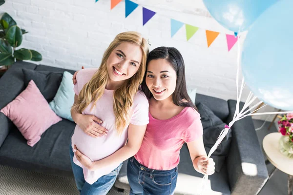 High angle view of multicultural friends looking at camera at baby shower party — Stock Photo