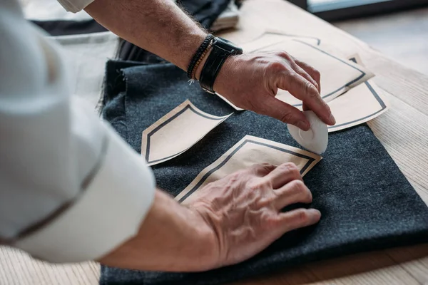 Plan recadré de tissu de marquage tailleur avec de la craie à l'atelier de couture — Photo de stock