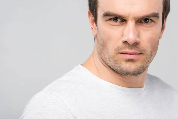 Portrait of handsome confident man looking at camera, isolated on grey — Stock Photo