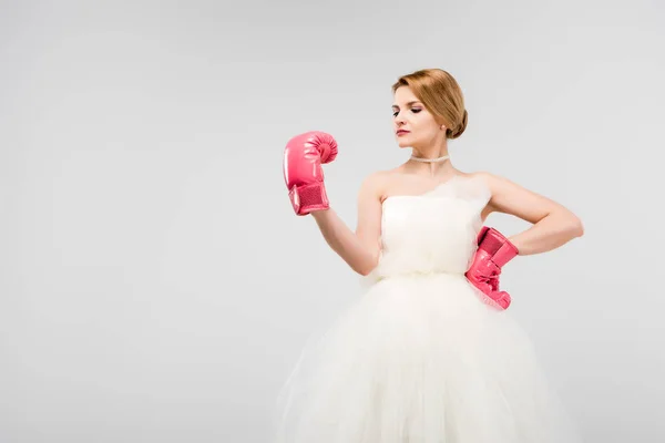 Strong bride posing in wedding dress and boxing gloves, isolated on grey, feminism concept — Stock Photo