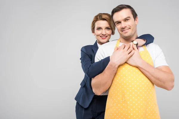 Businesswoman and male householder hugging together, feminism concept, isolated on grey — Stock Photo