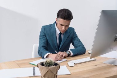 Young businessman at workplace clipart