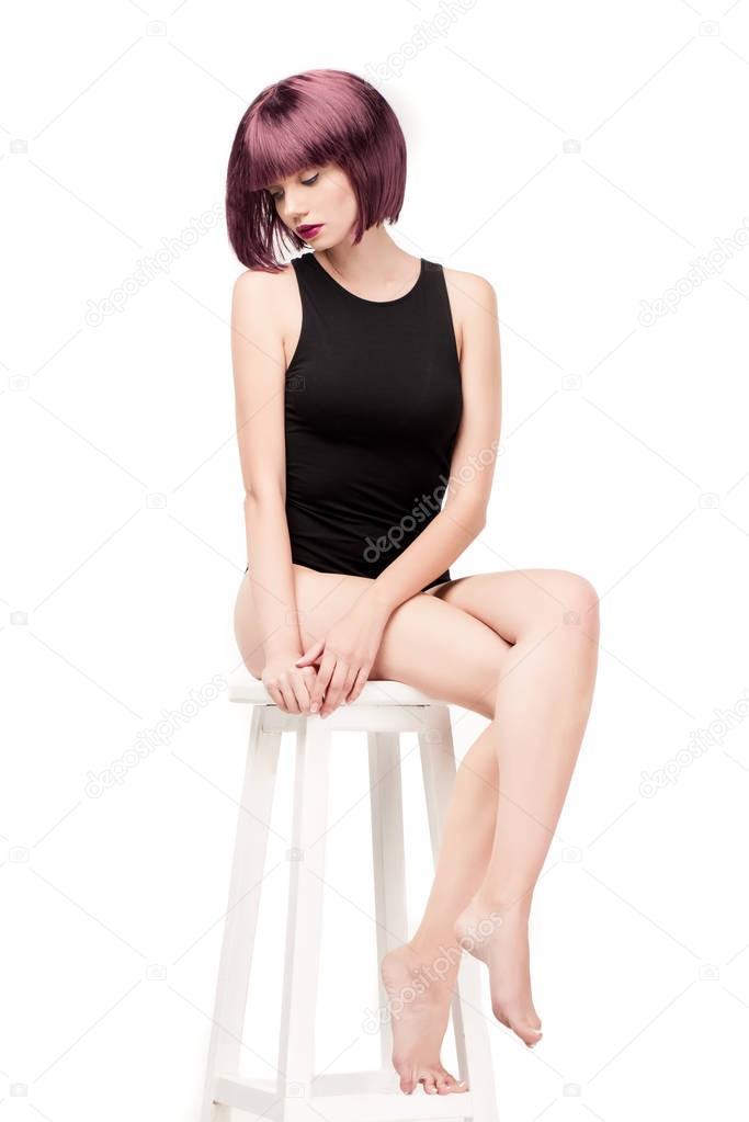 woman in leotard sitting on chair