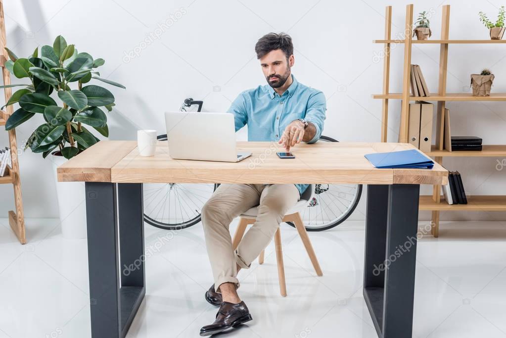 businessman with laptop at workplace