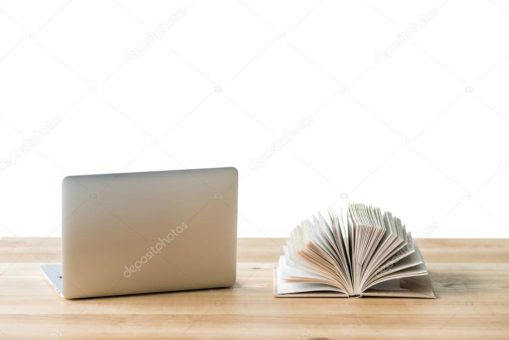 laptop and book on table