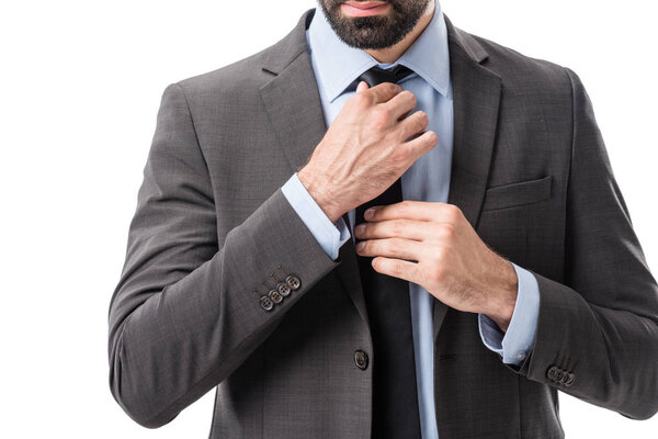 businessman tying necktie