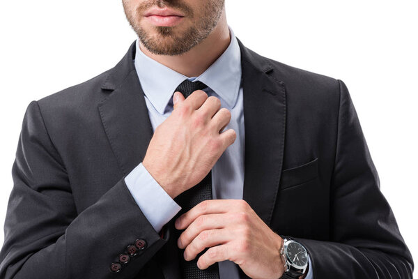 businessman tying necktie