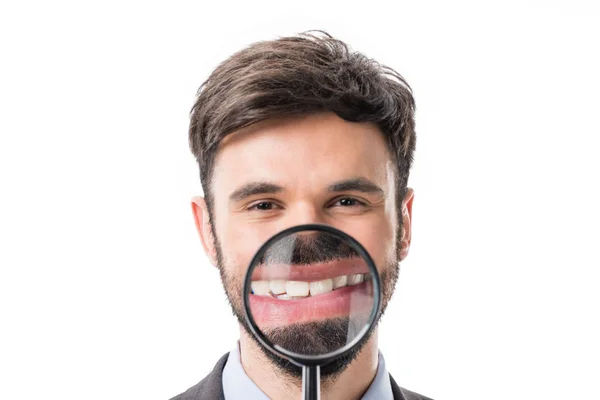 Businessman with magnifying glass — Stock Photo, Image