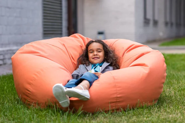 African american girl on bean bag chair — Stock Photo, Image