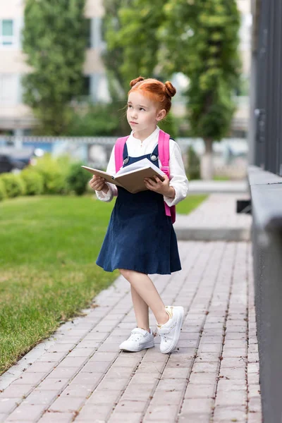 Redhead schoolgirl holding book — Stock Photo, Image