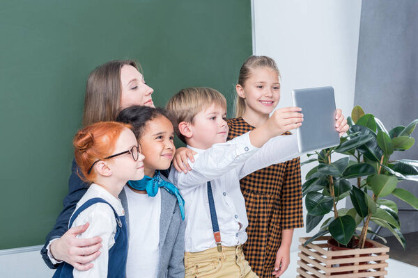 teacher with students taking selfie