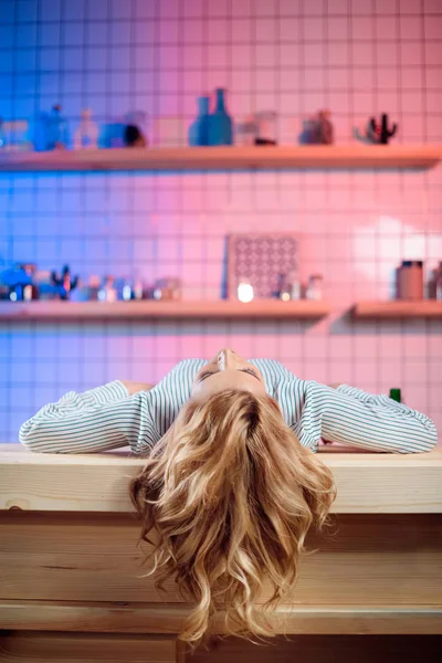 Woman lying on bar counter — Free Stock Photo