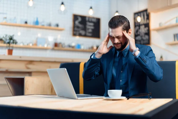 Businessman using laptop in cafe — Stock Photo, Image