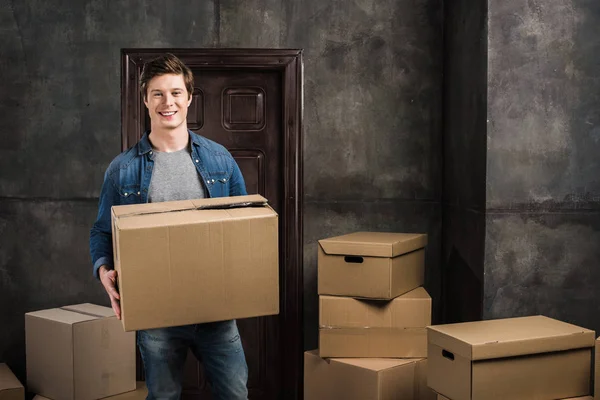 Cheerful man moving at new home — Stock Photo, Image
