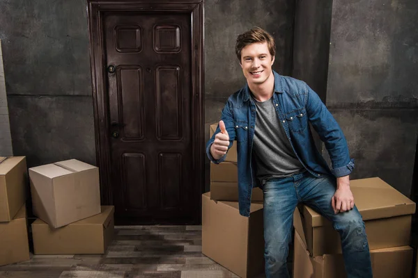 Man showing thumb up at new home — Stock Photo, Image