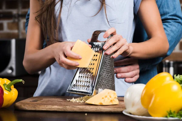 Woman grating cheese — Stock Photo, Image