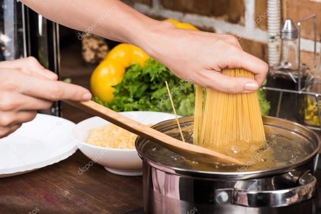Woman cooking pasta for dinner — Stock Photo © EdZbarzhyvetsky 168569024