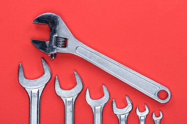 Various wrenches on red clipart
