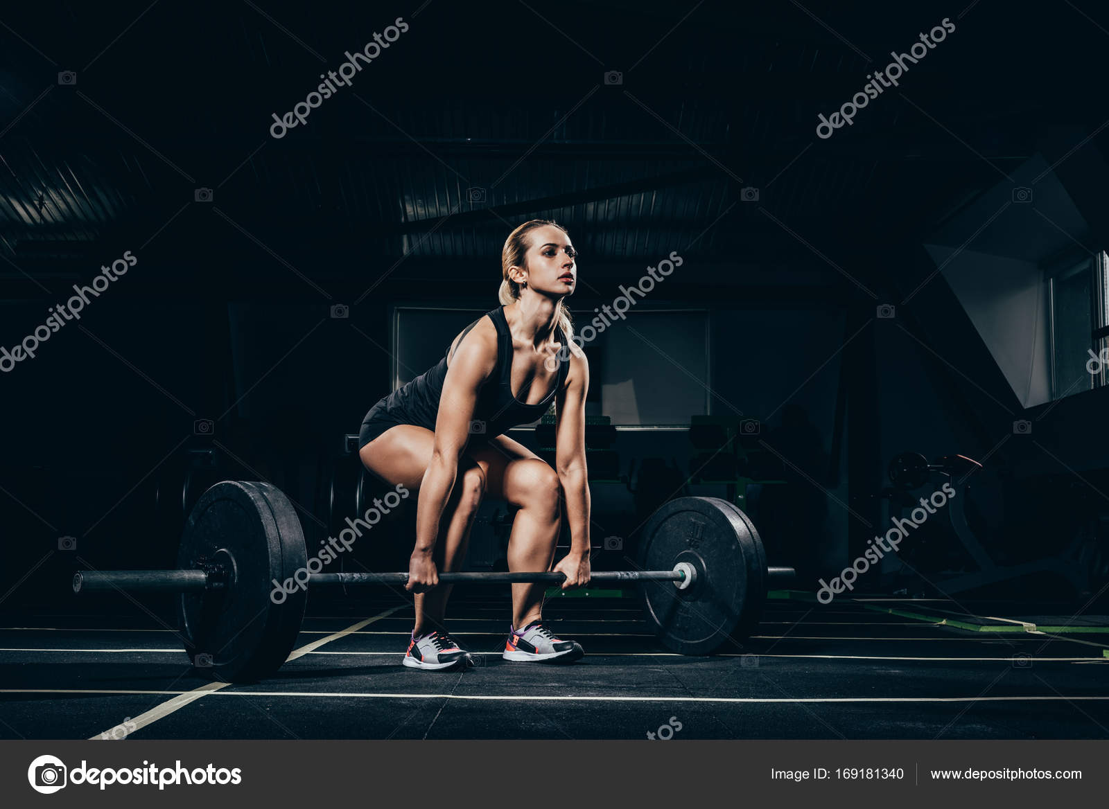 Sportswoman lifting barbell Stock Photo by ©EdZbarzhyvetsky 169181340