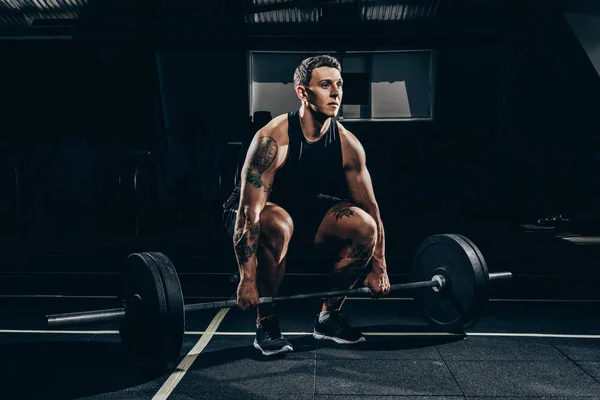 Sportsman lifting barbell — Stock Photo, Image