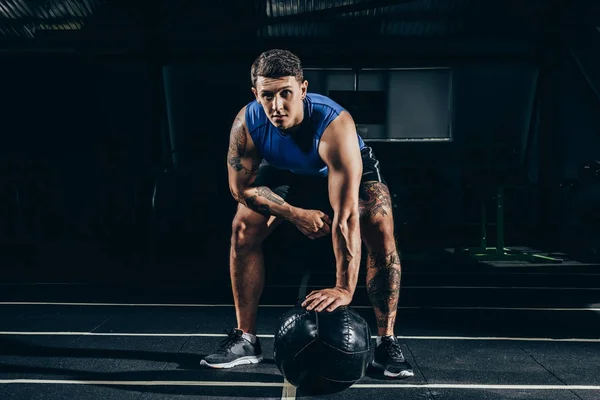 Sportsman with weighted ball — Stock Photo, Image