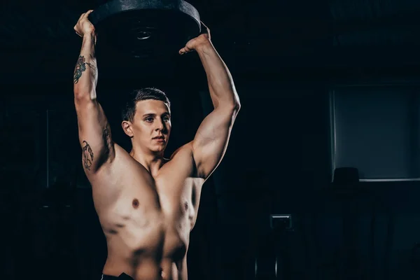 Sportsman holding barbell weight — Stock Photo, Image