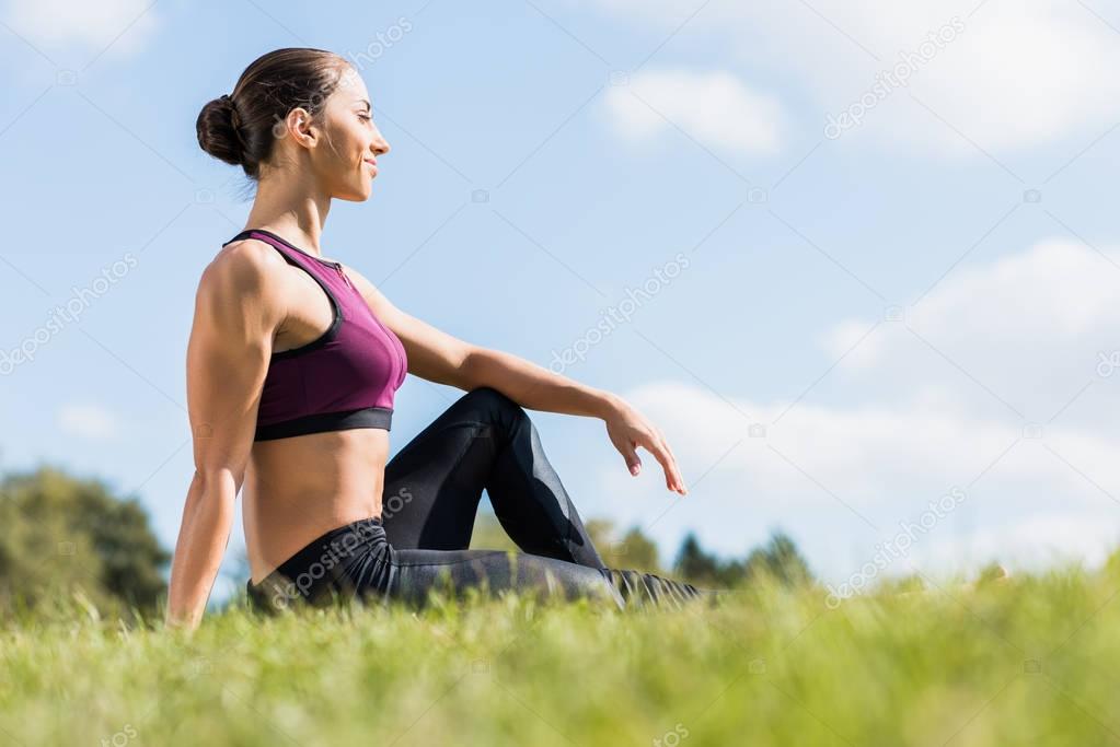 sportswoman sitting on grass