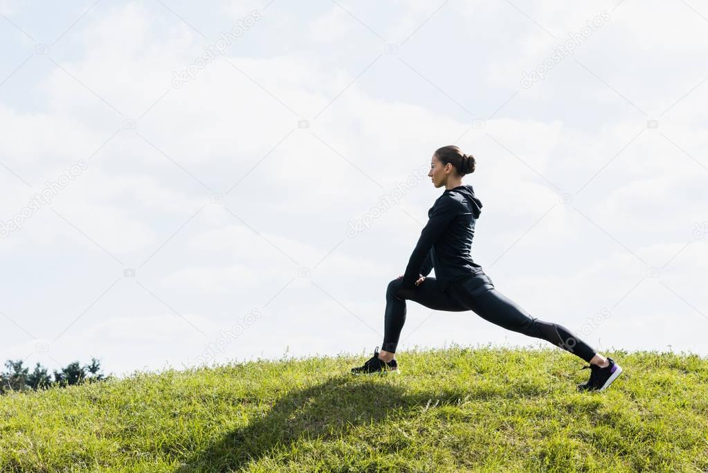 fit woman stretching legs