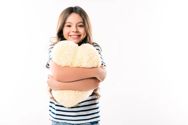 Child hugging heart shaped pillow — Stock Photo, Image
