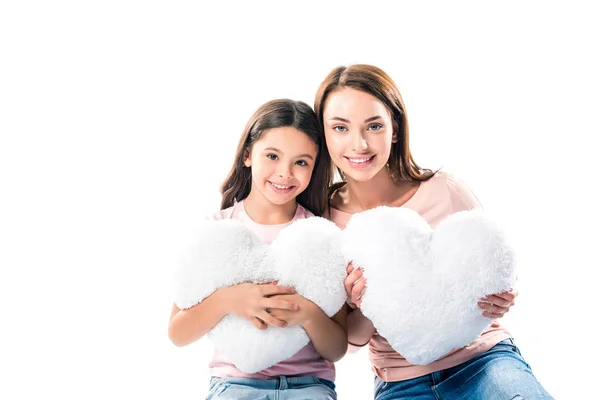 Daughter and mother with heart shaped pillows — Stock Photo, Image