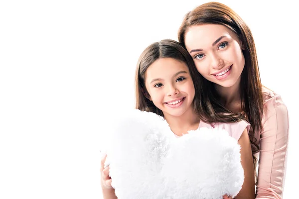 Mother and daughter with heart shaped pillow — Stock Photo, Image